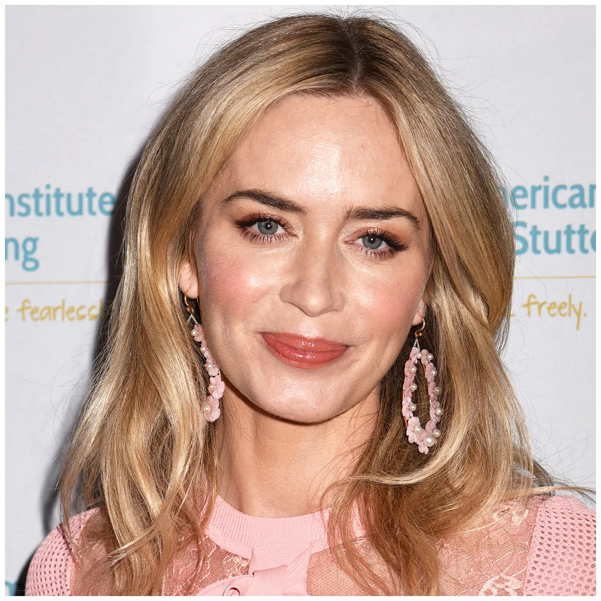 Is a vision in white as she steps out in a bandeau top and