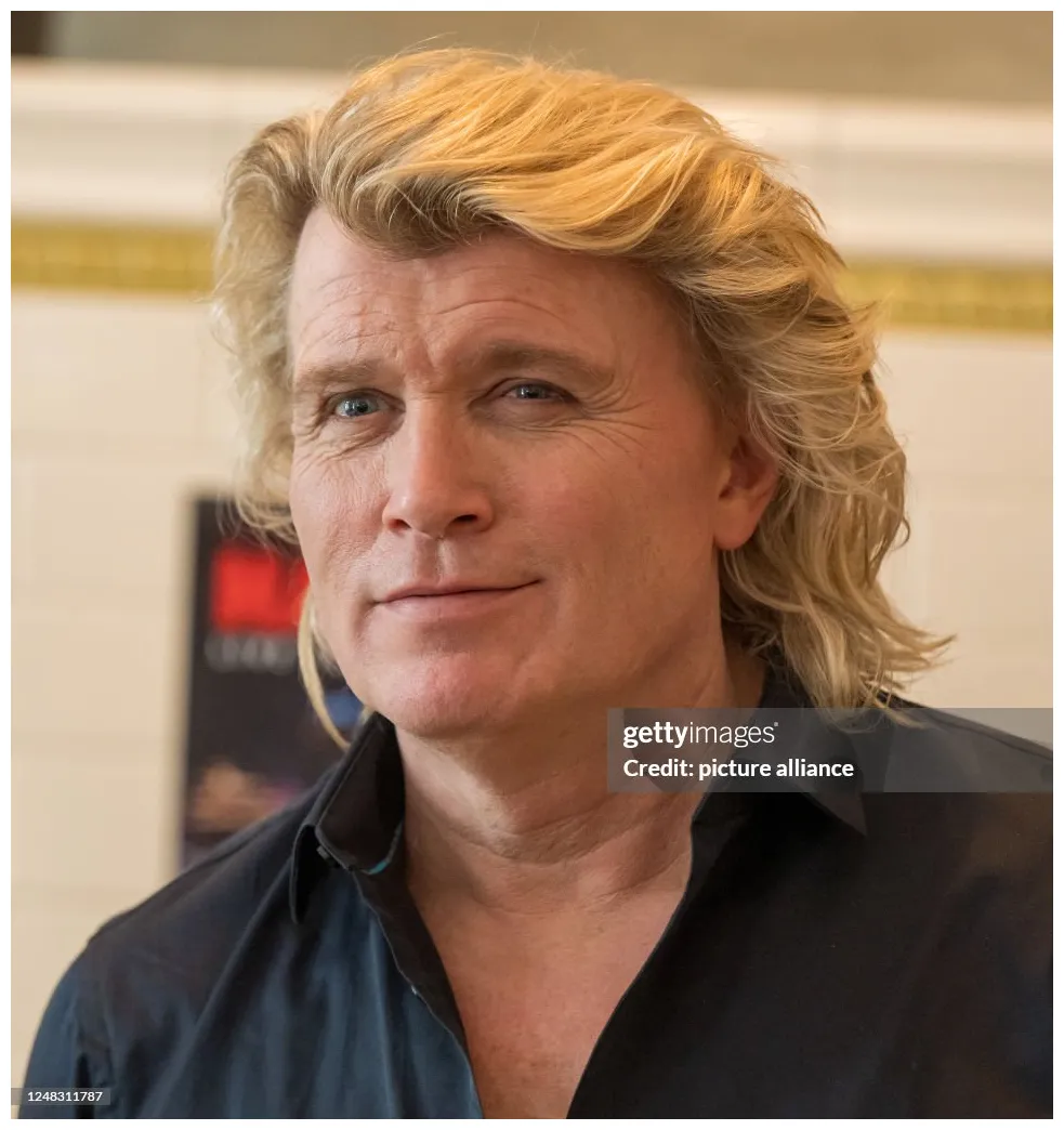 Magician poses for the press during the announcement for