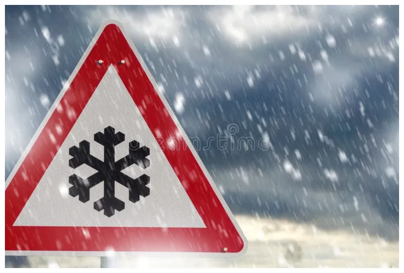 Road sign snow warns of snow and ice in winter, warning sign stock