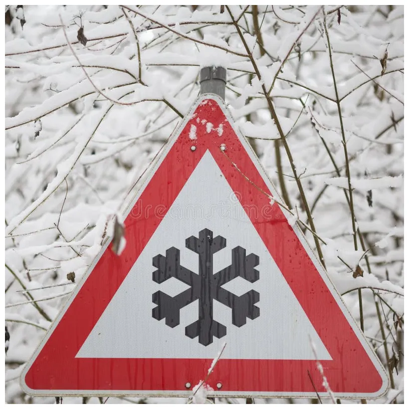 Warning sign shows danger of ice and snow at street stock