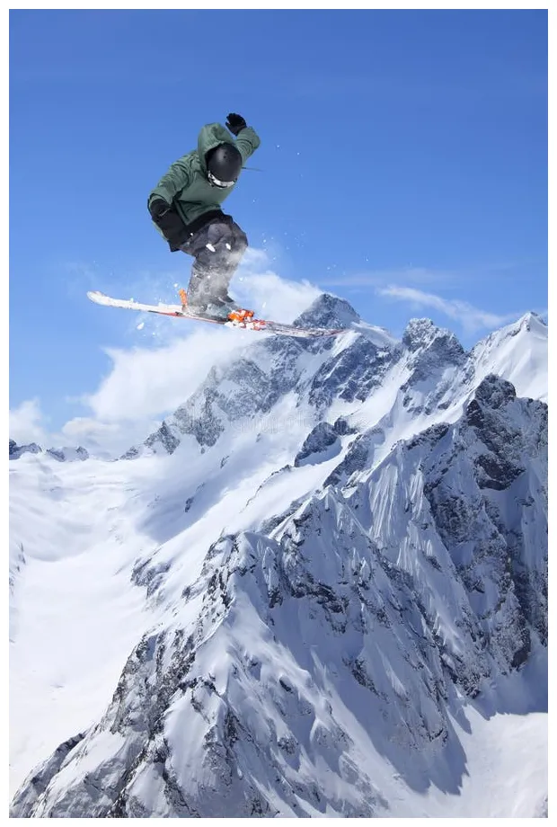 Skier jump in the mountains. extreme ski sport. freeride. stock